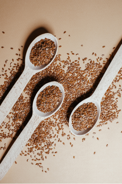 Brown flaxseeds on wooden spoons
